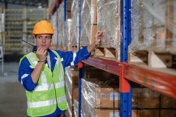 portrait of a smart Caucasian male engineer inspector checking confidence with a background of the warehouse of product stock