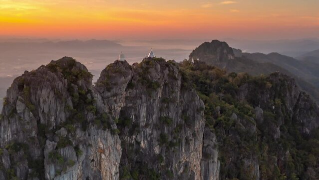 Video 4K solution, White pagoda and stupa on top of a mountain cliff in woodland called Wat Phra Bat Pupha Daeng temple, Chae Hom, Lampang province, Thailand.