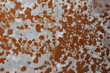 Brown peeling paint on the wall. Old concrete wall with cracked flaking paint. Weathered rough painted surface with patterns of cracks and peeling. High resolution texture for background and design.