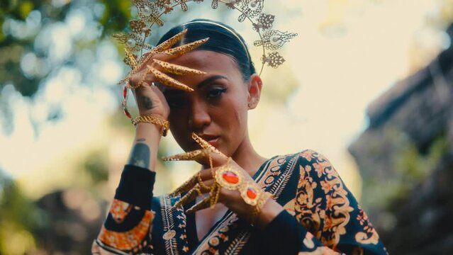 Woman Posing With Golden Claws And Headdress