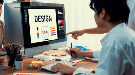 Graphic designer work on computer laptop and with graphic drawing pen while brainstorming unique...