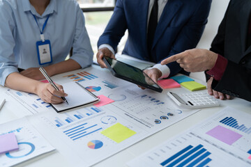 Colleagues meeting in business team discuss work analytics with financial data and graph report market growth in team. Brainstorming meeting, information recording, ideas. Communication concept.