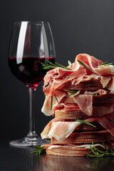 Spanish jamon or Italian prosciutto with bread, rosemary, and red wine.