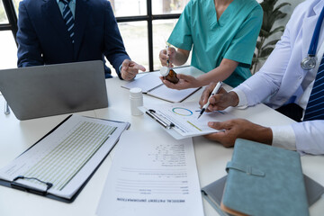 Medical Meeting for teams in the office to discuss, brainstorm and plan research. Medicine, doctors, nurses and laptops record data together showing diversity teamwork or a workshop for data analysis