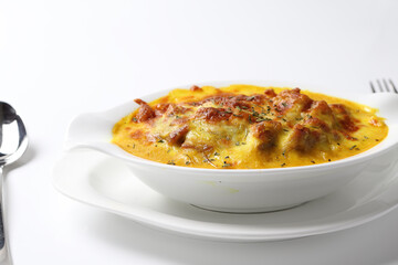 oven baked creamy cheese Japanese curry pasta fried rice with chicken seafood in bowl on brown cloth white background fork spoon western chef cuisine halal food menu for cafe