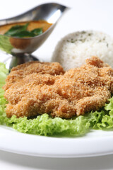 crispy deep fried chicken chop fish cutlet lettuce serve with nonya spicy malay curry leaf sauce and jasmine rice on grey cloth white background design asian chef cuisine halal food menu for cafe