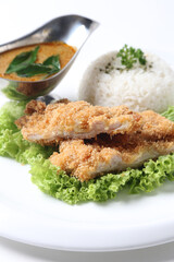 crispy deep fried chicken chop fish cutlet lettuce serve with nonya spicy malay curry leaf sauce and jasmine rice on grey cloth white background design asian chef cuisine halal food menu for cafe