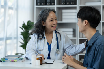 Health care and treatment concept. Senior female doctor doing consultation. And encourage patients to fight the patient's disease and taking medicine, taking care of their own health.