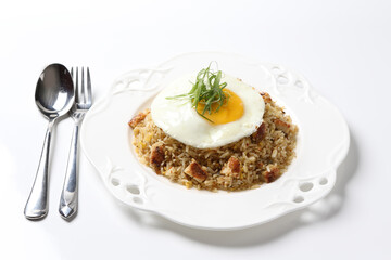 Japanese unagi fish seafood wok garlic fried rice with fried egg and vegetables in plate on vintage table cloth white background asian chef cuisine halal food menu for cafe