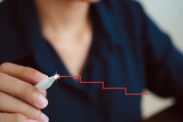Businessman uses red outline pen for steps of growth and progress concept.