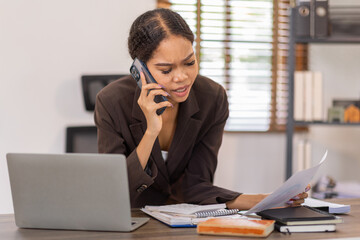 Corporate Communication. Asian Business woman using calculator and laptop for doing math finance, Asian Businesswoman Talking On Mobile Phone Working On Laptop In Modern Office. Free Space