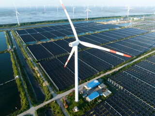 solar power panels and wind turbines on beach