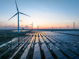 solar power panels and wind turbines on beach