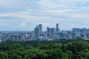 Fototapeta na wymiar 荒井山緑地から見下ろした札幌市街地のビル群
