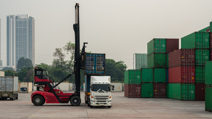Forklift Truck loading Container to Cargo Truck Forklift working in the container cargo yard port...