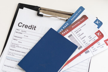 a passport, a flight ticket, differnt currencys on a white surface.