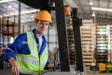 Industrial worker driving a forklift in the factory. The engineer is working and maintaining the warehouse.