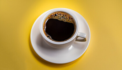 Black coffee in a cup on a yellow background