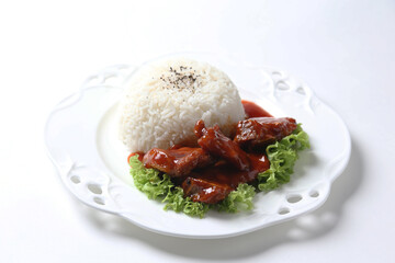 stir fried fresh pork ribs, fish, chicken meat in sweet and sour ketchup tomato sauce with jasmine rice and lettuce on wood tray white background asian chef halal food restaurant banquet cafe menu
