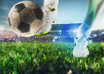 Football scene with close up of a soccer shoe hitting the ball with power