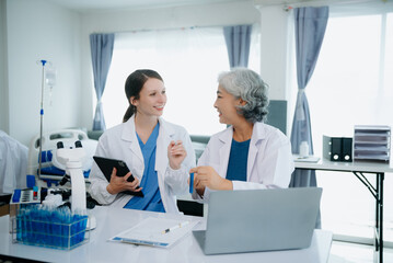 Medical team having a meeting with doctors. Young scientists conducting research investigations in a medical laboratory, a researcher.