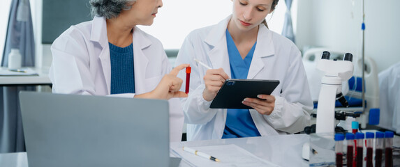 Medical team having a meeting with doctors. Young scientists conducting research investigations in a medical laboratory, a researcher.