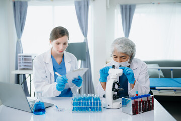 Medical team having a meeting with doctors. Young scientists conducting research investigations in a medical laboratory, a researcher.