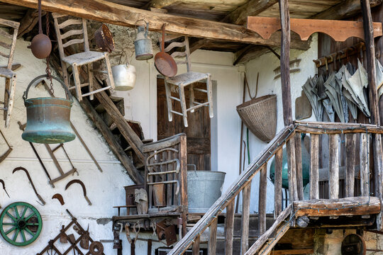 Rustic Italian mountain house balcony full of vintage objects. Poffabro village, Pordenone province, Friuli Venezia Giulia, Italy.