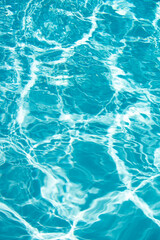 Fototapeta na wymiar Blue pool water background. Blurred transparent clear calm water surface texture. Water waves in sunlight with copy space.
