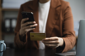 women holding hand credit card.businessman use smartphone online payments shopping in the morning.