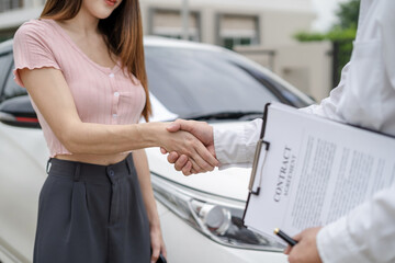 Close up shake hands, Car Dealership and sign contracts in car showrooms or car dealership offices, successful deal.