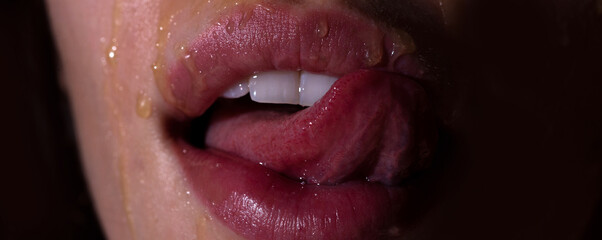 Honey drip on mouth. Licking tongue honey. Glamour art lips concept. Sensual lick.