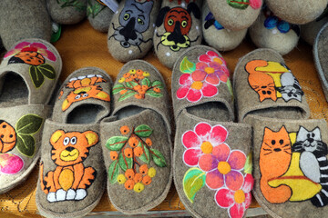 home slippers made of felted wool with a variety of colored appliqués
