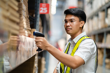 Male warehouse worker scanning barcodes on boxes in a warehouse. Male warehouse worker working with barcode scanner.