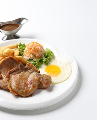 grilled golden bbq chicken chop pork cutlet beef steak with fried egg, French fries, coleslaw salad and black pepper sauce on brown leather white background western chef halal food restaurant menu