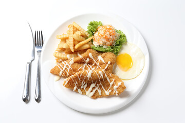 deep fried golden crispy fish fillet and chips with fried egg, French fries, coleslaw salad in tartar sauce on brown leather white background western chef halal food restaurant banquet menu cafe