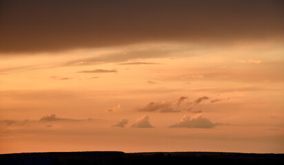 Pink clouds and evening sunset sky after a thunderstorm. Blue-red sunset evening. Beautiful pink clouds.