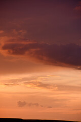 Fototapeta premium Pink clouds and evening sunset sky after a thunderstorm. Blue-red sunset evening. Beautiful pink clouds.
