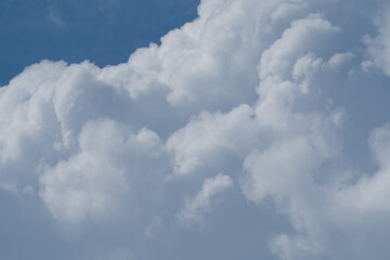 Naklejka na ściany i meble white fluffy clouds standing out against a blue sky