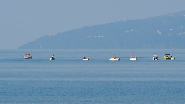 Footage of amateur fishermen fishing with their boats.
