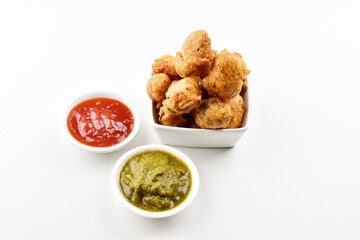 Dal pakoda with chutney isolated on white background