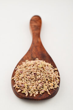 Closeup of carom seeds in wooden spoon