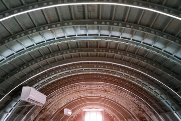 Arched roof steel structure the design for framework look like tunnel with sunlight background.