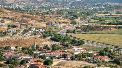 Fototapeta na wymiar Bademli Village houses with wide agricultural fields view from Kalekoy hill in Gokceada island. Canakkale, Turkey. Aerial view.