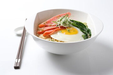 cook Japanese instant noodle mee soup with chicken ham, fried egg and vegetables on bowl chopstick on white vintage newspaper background asian chef halal food restaurant banquet menu