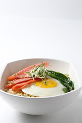 cook Japanese instant noodle mee soup with chicken ham, fried egg and vegetables on bowl chopstick on white vintage newspaper background asian chef halal food restaurant banquet menu