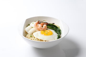 cook Japanese instant noodle mee soup with seafood fish, prawn, octopus, fried egg and vegetables on bowl chopstick on white vintage newspaper background asian chef halal food restaurant banquet menu