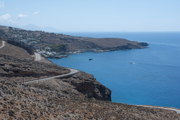 Panoramic view of the mountains of the Gorge and the Sea against the backdrop of the blue sky on the island of Crete Sunny Day