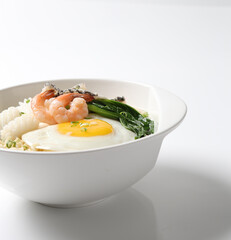 cook Japanese instant noodle mee soup with seafood fish, prawn, octopus, fried egg and vegetables on bowl chopstick on white vintage newspaper background asian chef halal food restaurant banquet menu