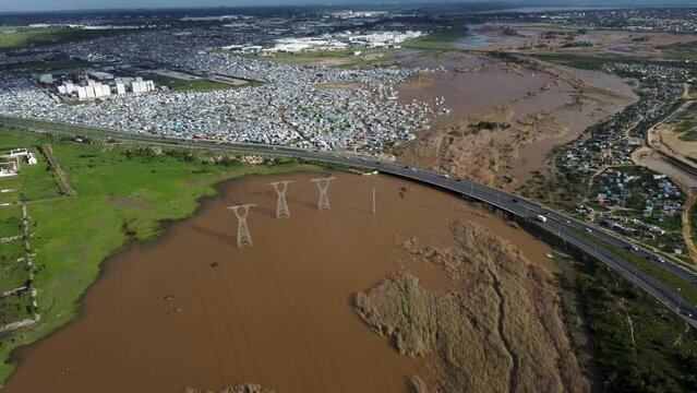 Aerial View of Flooded River Next to Township and Highway Bridge, Cape Town, South Africa